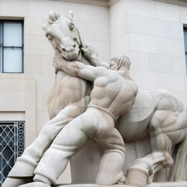 Statue of man holding horse