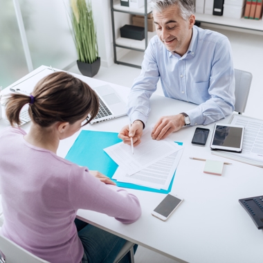 employee reading over handbook with employer