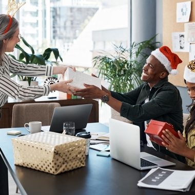People at work giving one another gifts
