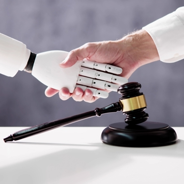 A person shaking hands with a robot in front of a gavel