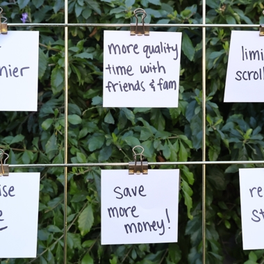 Resolutions written on small pieces of paper attached to a sort of vision board