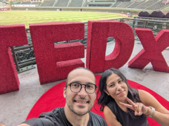 people in front of TEDx logo