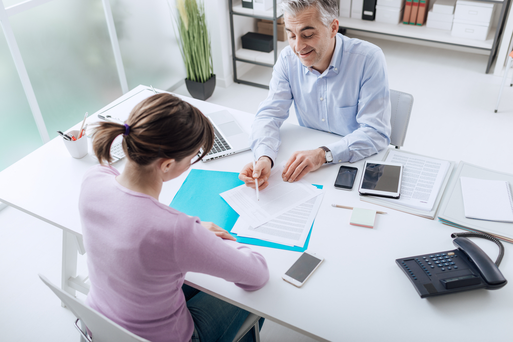 employee reading over handbook with employer
