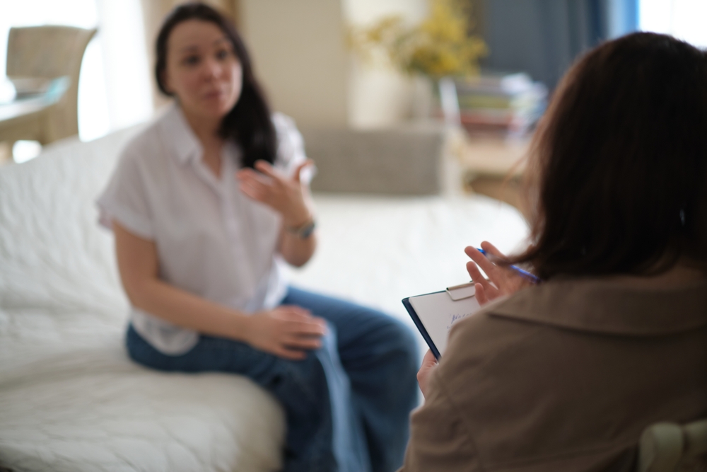 A therapist speaking with a patient.