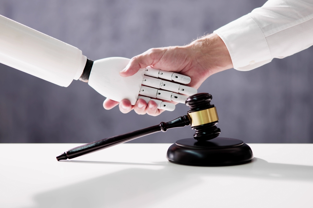 A person shaking hands with a robot in front of a gavel