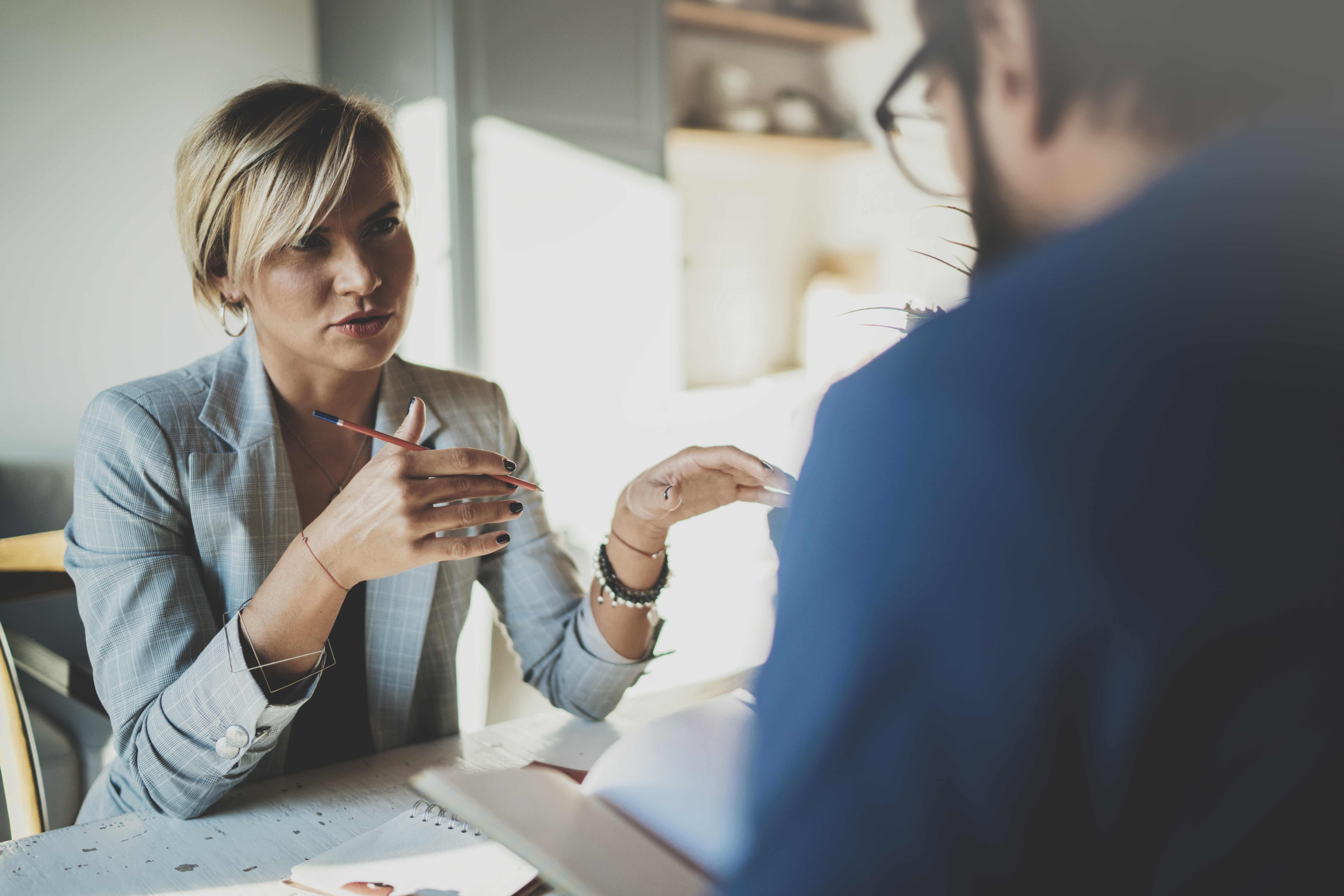 Professional Woman Speaking With Coworker